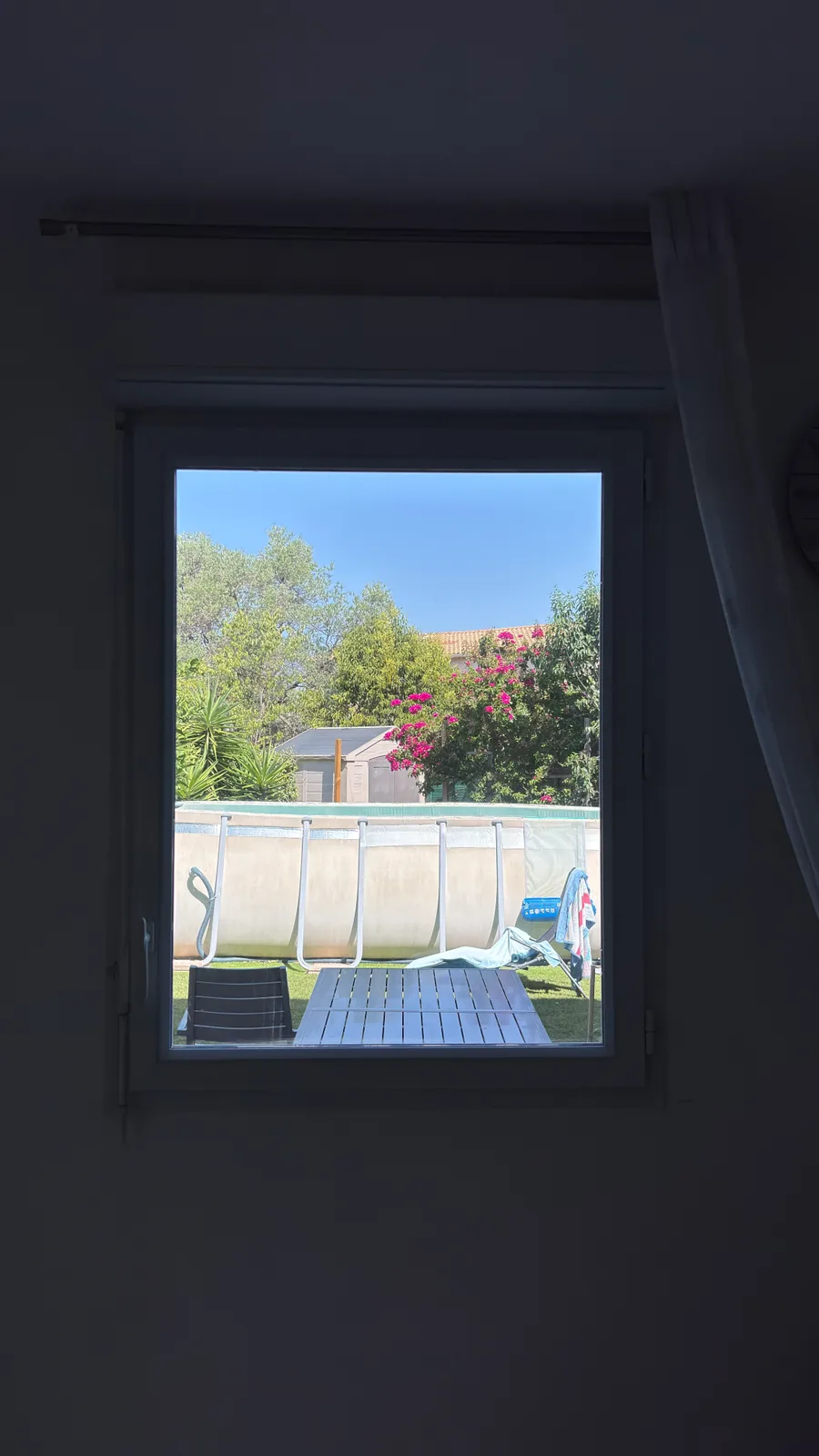 Vue depuis l'intérieur de la chambre après pose du film miroir sans tain à Hyères : la vue sur le jardin et la luminosité sont conservées