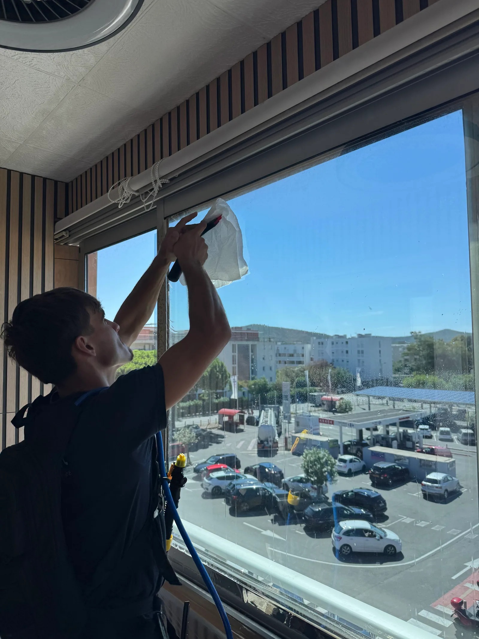 Technicien PrivTeint posant un film solaire sur la fenêtre d’un bureau à Hyères