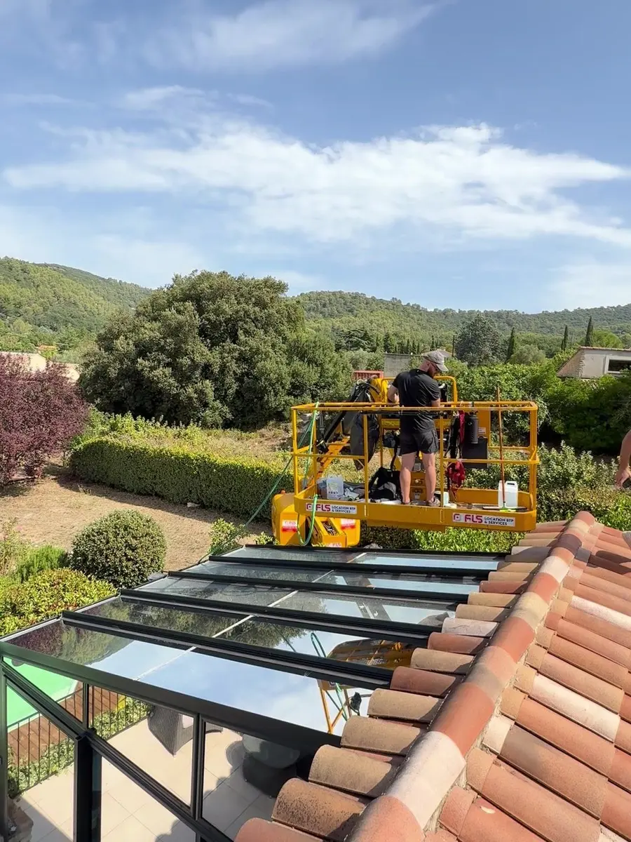 Deux techniciens PrivTeint en nacelle au-dessus d'une verrière, pose d'un film solaire sur la toiture vitrée dans le Var