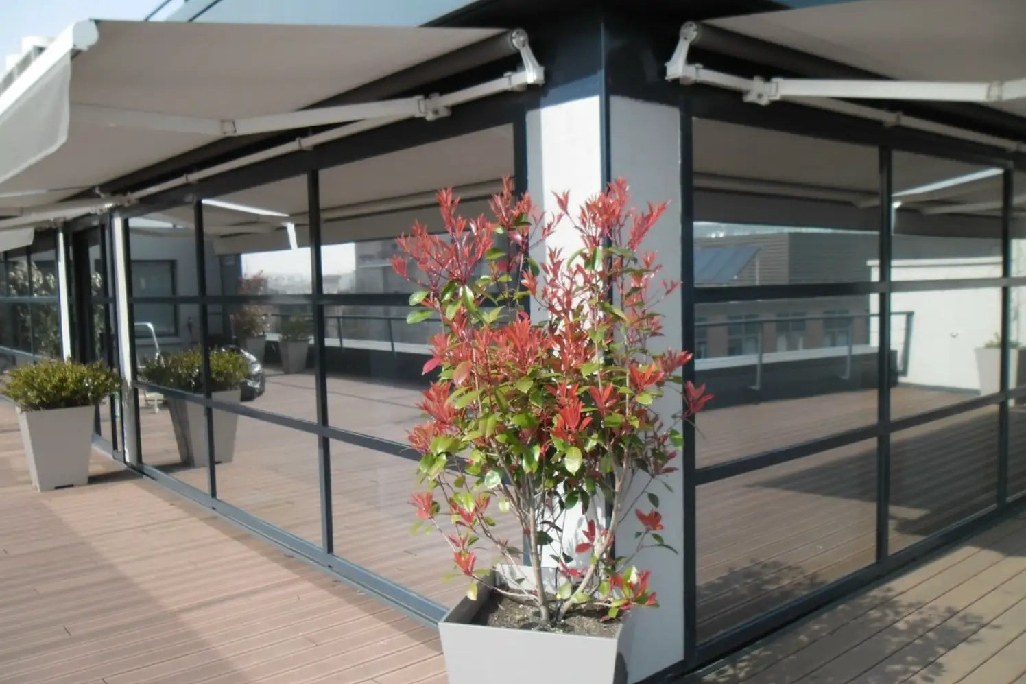 Véranda vitrée sur terrasse avec film solaire PrivTeint, réduction de chaleur, anti-UV et confort visuel sans assombrir.